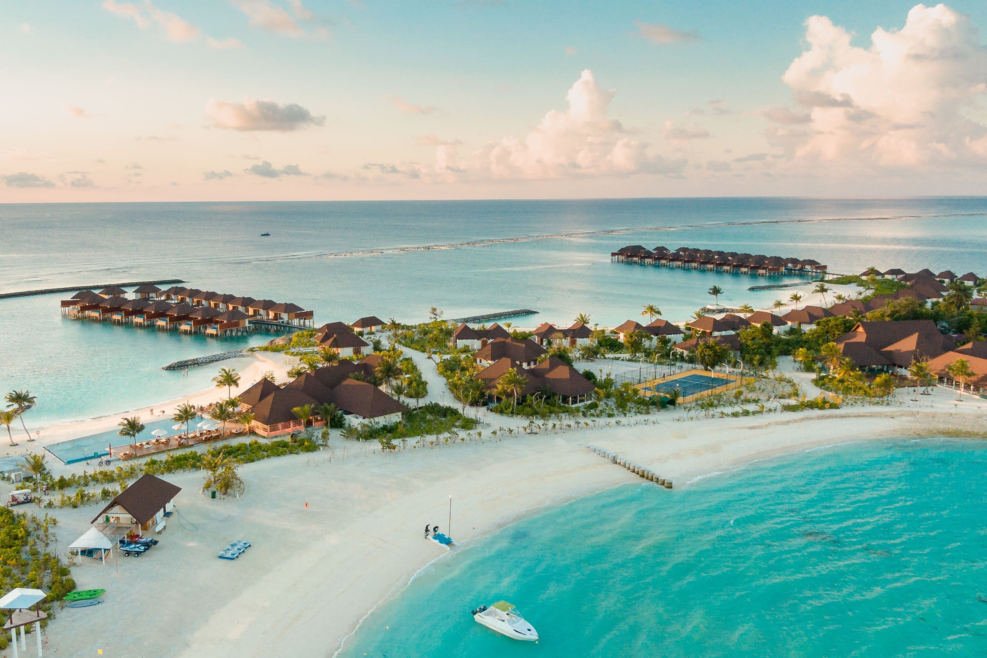 Aerial view of an overwater resort at dusk
