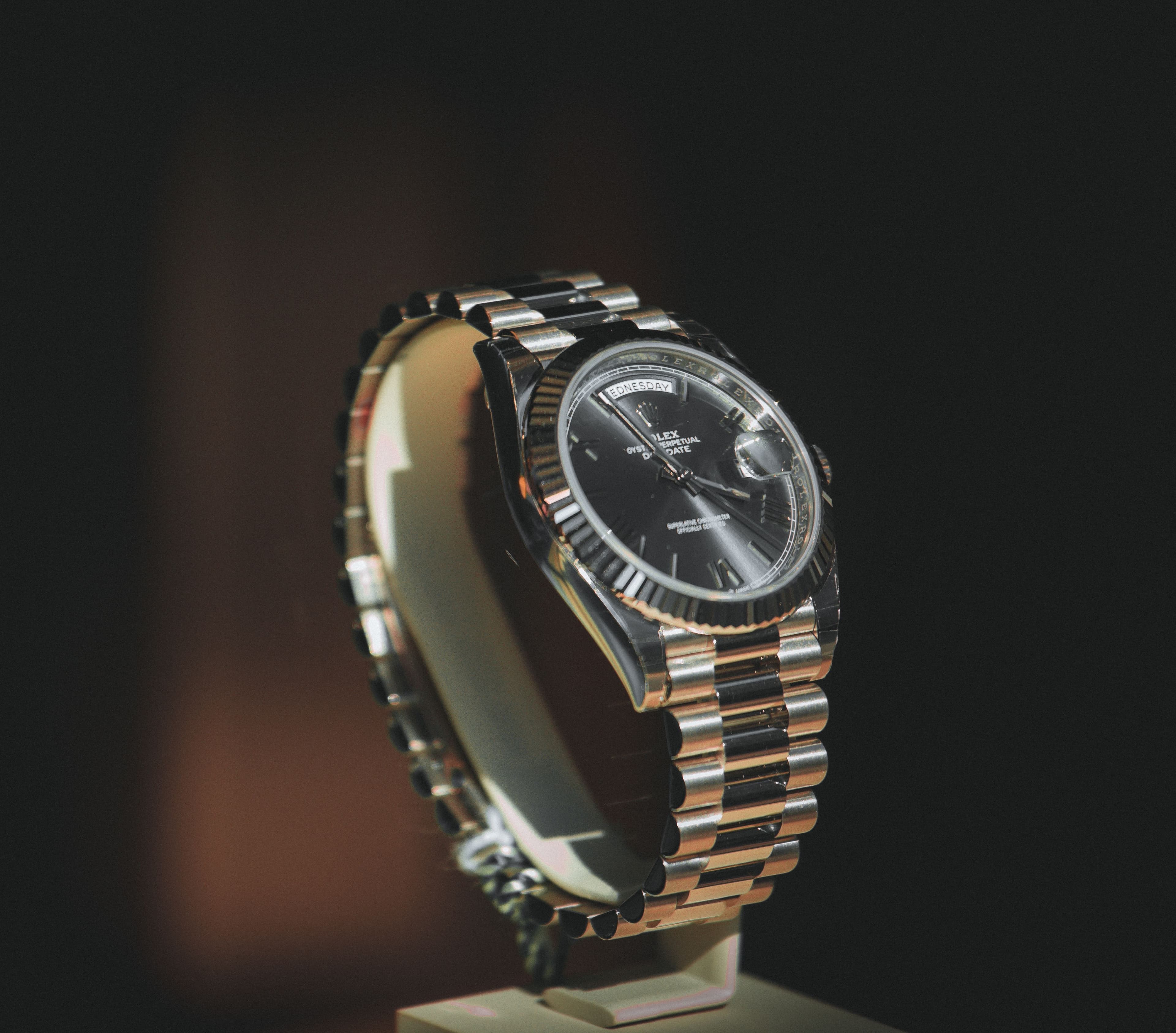 Rolex Day-Date watch displayed on a boutique presentation stand